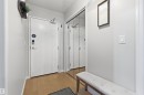 Entryway featuring light wood flooring, a white door with a modern lock, and mirrored closet doors - 316 141 Festival Way, Sherwood Park, AB  - Indoor Photo Showing Other Room 