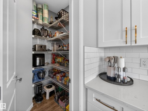 Spacious pantry with wire shelving, offering extensive storage capacity - 3210 Chernowski Way, Edmonton, AB - Indoor