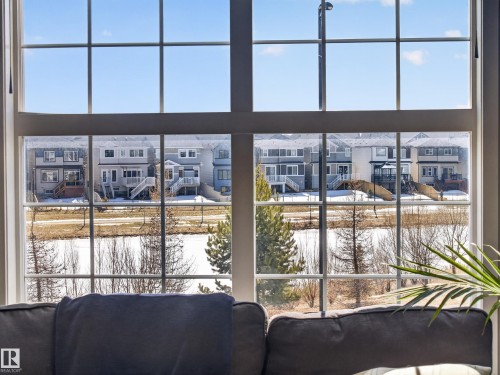 Large window offering views of the surrounding neighborhood and a body of water - 3210 Chernowski Way, Edmonton, AB - Indoor