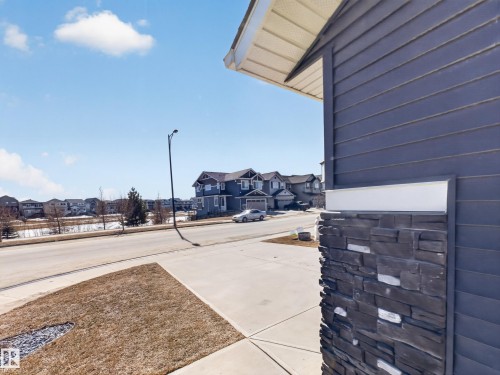 The property exterior features horizontal siding and a stone accent column - 3210 Chernowski Way, Edmonton, AB - Outdoor