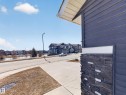 The property exterior features horizontal siding and a stone accent column - 3210 Chernowski Way, Edmonton, AB  - Outdoor 