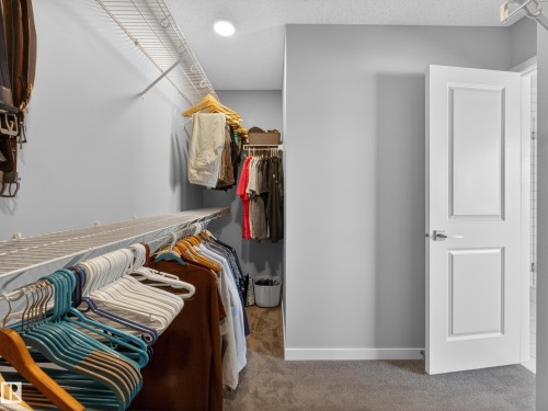 The closet features wire shelving and hanging rods, providing ample storage solutions - 3210 Chernowski Way, Edmonton, AB - Indoor