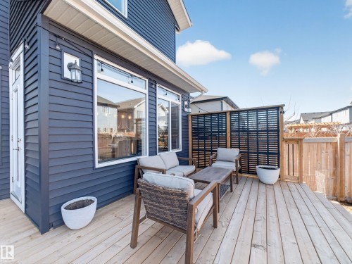 This property features a spacious wooden deck, perfect for outdoor enjoyment - 3210 Chernowski Way, Edmonton, AB - Outdoor With Deck Patio Veranda With Exterior