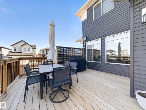 Expansive wooden deck with railing, featuring a privacy screen and ample space for outdoor living - 3210 Chernowski Way, Edmonton, AB - Outdoor With Deck Patio Veranda With Exterior