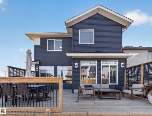 The property features a spacious wooden deck, perfect for outdoor enjoyment - 3210 Chernowski Way, Edmonton, AB - Outdoor With Deck Patio Veranda With Exterior
