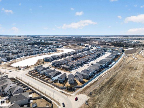 Aerial view of a residential neighbourhood featuring numerous properties with dark-colored roofs - 3210 Chernowski Way, Edmonton, AB - Outdoor With View