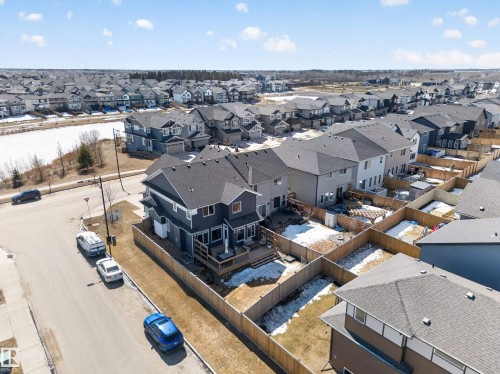 The property features a private backyard with a wooden fence and a deck - 3210 Chernowski Way, Edmonton, AB - Outdoor With View