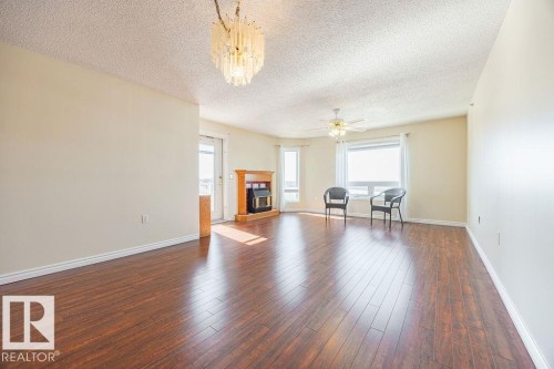 #305 9926 100 Av, Fort Saskatchewan, AB - Indoor Photo Showing Living Room With Fireplace