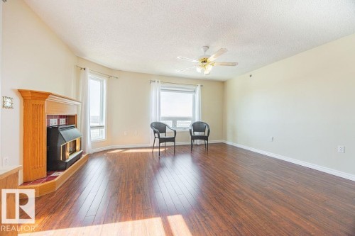 #305 9926 100 Av, Fort Saskatchewan, AB - Indoor Photo Showing Living Room With Fireplace