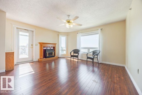 #305 9926 100 Av, Fort Saskatchewan, AB - Indoor Photo Showing Living Room With Fireplace