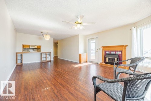 #305 9926 100 Av, Fort Saskatchewan, AB - Indoor Photo Showing Living Room With Fireplace
