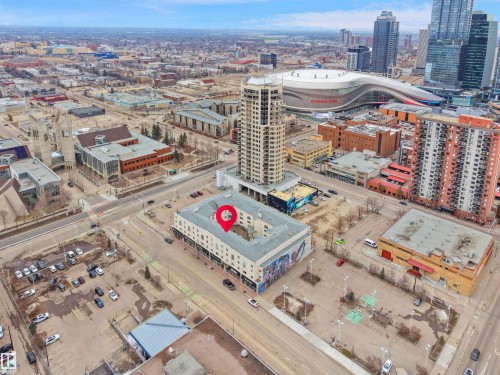 Aerial view highlighting the property's central location amidst a vibrant urban landscape, featuring surrounding buildings and established infrastructure - 10 10331 106 Street, Edmonton, AB - Outdoor With View