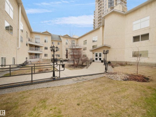 The property features a multi-story building with a light-colored stucco exterior - 10 10331 106 Street, Edmonton, AB - Outdoor