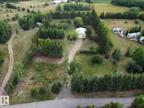 Aerial view of the property, featuring extensive green spaces and mature trees - Lot 118 Homestead Trail, Rural St. Paul County, AB 