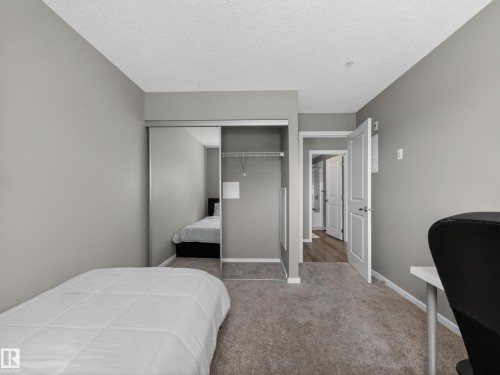 Bedroom with neutral-toned carpet flooring and light gray walls - 124 148 Ebbers Boulevard, Edmonton, AB - Indoor Photo Showing Bedroom