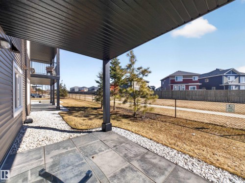 The property features a patio with large square pavers and an overhead covering - 124 148 Ebbers Boulevard, Edmonton, AB - Outdoor With Exterior