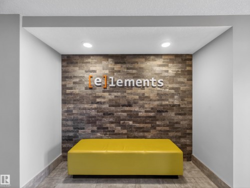 The property features an entryway with a textured accent wall and recessed lighting, creating a welcoming atmosphere - 124 148 Ebbers Boulevard, Edmonton, AB - Indoor Photo Showing Other Room