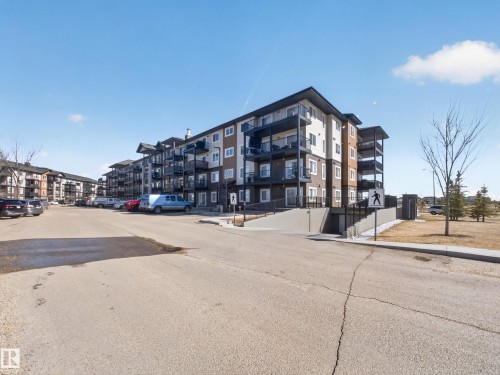 The building facade features a contemporary design with multi-toned siding and private balconies - 124 148 Ebbers Boulevard, Edmonton, AB - Outdoor