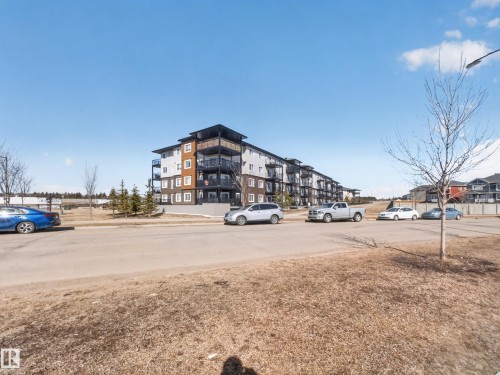 The property is a low-rise apartment building with multiple floors and balconies - 124 148 Ebbers Boulevard, Edmonton, AB - Outdoor