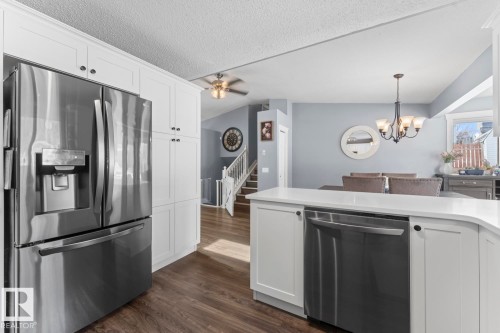 The kitchen features white cabinetry, stainless steel appliances, and a white quartz countertop - 1929 Forest Drive, Cold Lake, AB - Indoor Photo Showing Kitchen