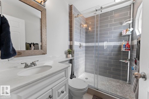 This bathroom features a contemporary shower with grey subway tile and a glass enclosure - 1929 Forest Drive, Cold Lake, AB - Indoor Photo Showing Bathroom