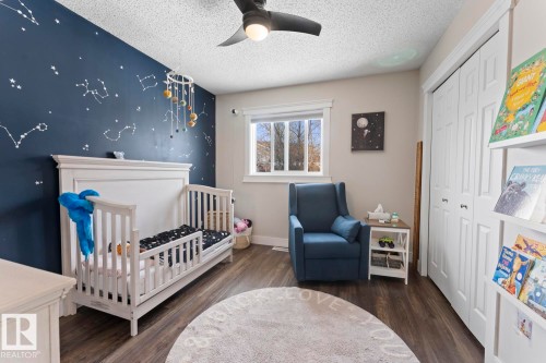 This room features vinyl plank flooring, a window providing natural light, and a ceiling fan - 1929 Forest Drive, Cold Lake, AB - Indoor Photo Showing Bedroom