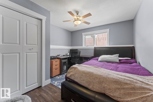 The room features vinyl plank flooring, a window with white trim, and a ceiling fan - 1929 Forest Drive, Cold Lake, AB - Indoor Photo Showing Bedroom