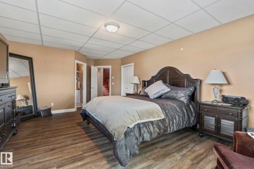 This spacious room features wood-look flooring and a drop ceiling - 9610 167 Street Sw, Edmonton, AB - Indoor Photo Showing Bedroom