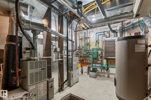 The property features a utility room with multiple HVAC units, extensive ductwork, and various plumbing systems - 9610 167 Street Sw, Edmonton, AB - Indoor Photo Showing Basement