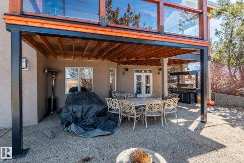 The property features a spacious covered patio area with a concrete surface - 9610 167 Street Sw, Edmonton, AB - Outdoor With Deck Patio Veranda