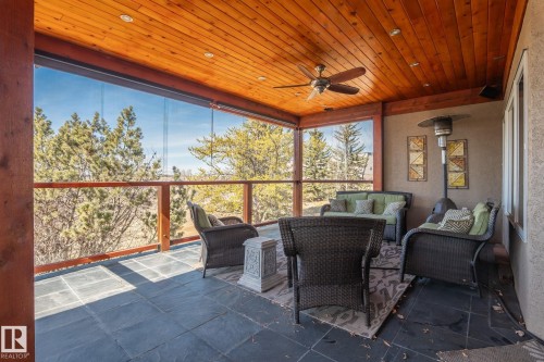 The property features an expansive outdoor living area with a wood plank ceiling and a ceiling fan, providing comfort and style - 9610 167 Street Sw, Edmonton, AB - Outdoor With Deck Patio Veranda With Exterior