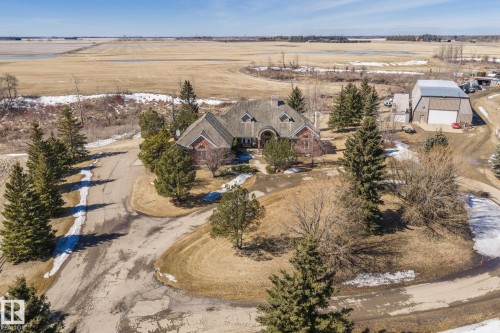 The property features a large building with a brown roof and red brick walls - 9610 167 Street Sw, Edmonton, AB - Outdoor With View