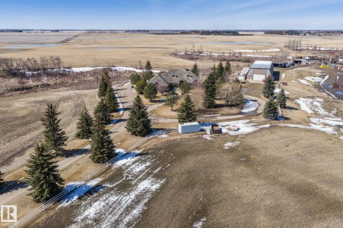 The property features an extensive driveway leading to a residence with a large, multi-gabled roof and an attached garage - 9610 167 Street Sw, Edmonton, AB - Outdoor With View