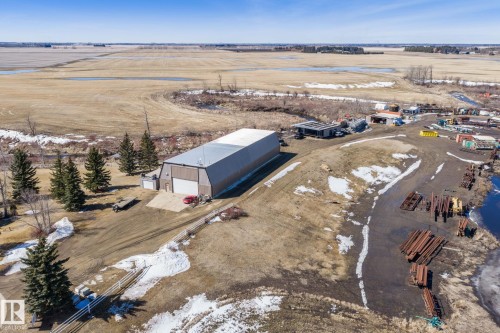 This property features a large Quonset-style building with a white roof and a wide front entrance - 9610 167 Street Sw, Edmonton, AB - Outdoor With View