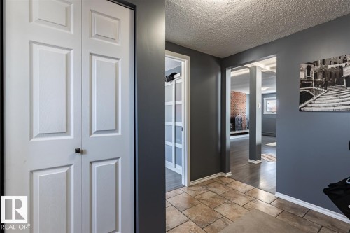 Foyer featuring tiled flooring and a white bi-fold door - 15204 94 Street, Edmonton, AB - Indoor Photo Showing Other Room