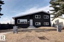 The property features a modern exterior with a dark facade, white window frames, and a white front door - 15204 94 Street, Edmonton, AB  - Outdoor 