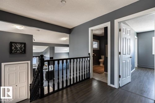 Upper level with dark wood flooring, grey walls, and white trim - 15204 94 Street, Edmonton, AB - Indoor Photo Showing Other Room
