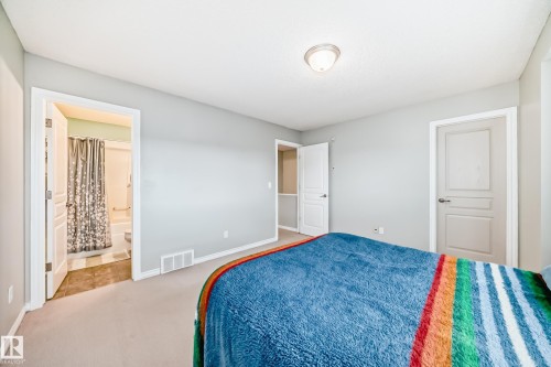 This bedroom features light grey walls and light-colored carpeting - 105 13825 155 Avenue, Edmonton, AB - Indoor Photo Showing Bedroom