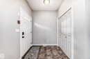 The property features a front entrance with a white door, a tiled floor, and a closet with bifold doors - 105 13825 155 Avenue, Edmonton, AB  - Indoor Photo Showing Other Room 