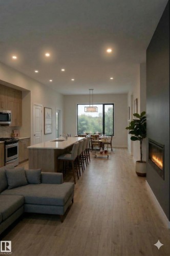 Open concept living space featuring recessed lighting, light wood flooring, a kitchen island with seating, a dining area, and a linear fireplace - 558 Ashgrove Circle, Leduc, AB - Indoor Photo Showing Living Room With Fireplace