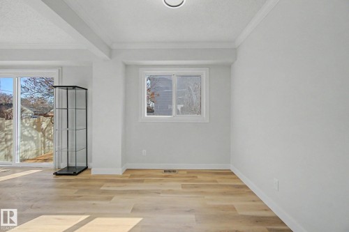 This room features light wood flooring, white walls, and a window providing natural light - 186 Centennial Crest, Edmonton, AB - Indoor Photo Showing Other Room