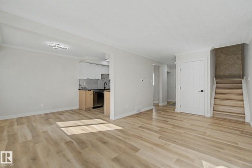 This bright and spacious living area features light-toned flooring and white walls, offering a neutral palette - 186 Centennial Crest, Edmonton, AB - Indoor