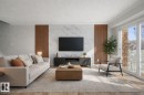 This living area features light-toned flooring, a decorative wall panel with a marble-effect design, and a large sliding glass door - 186 Centennial Crest, Edmonton, AB  - Indoor Photo Showing Living Room 