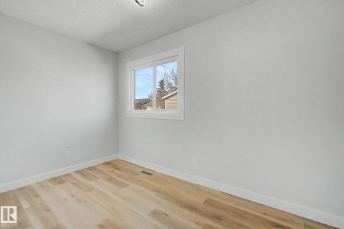 The room features light wood-style flooring and light-colored walls, providing a bright and neutral aesthetic - 186 Centennial Crest, Edmonton, AB - Indoor Photo Showing Other Room