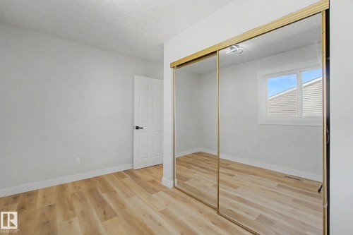 The room features light-toned flooring, white walls, and a white door with a black handle - 186 Centennial Crest, Edmonton, AB - Indoor Photo Showing Other Room