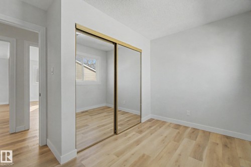 This bright room features light-colored flooring, white walls, and a window providing natural light - 186 Centennial Crest, Edmonton, AB - Indoor Photo Showing Other Room