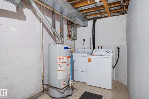 Utility area featuring a water heater, washer, and dryer - 186 Centennial Crest, Edmonton, AB - Indoor Photo Showing Laundry Room