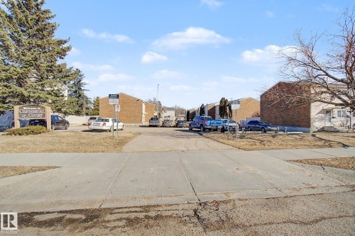 The property features a private parking area with a paved driveway and surrounding landscaped grounds - 186 Centennial Crest, Edmonton, AB - Outdoor