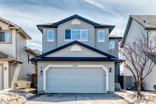 This property features a two-story design with light blue siding and a dark roof - 11415 167A Avenue, Edmonton, AB - Outdoor With Exterior