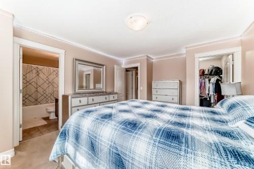 Bedroom featuring light-colored walls, a ceiling light fixture, and crown molding - 11415 167A Avenue, Edmonton, AB - Indoor Photo Showing Bedroom